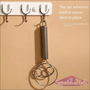 Stainless steel dough whisk hanging on hooks for convenient kitchen storage