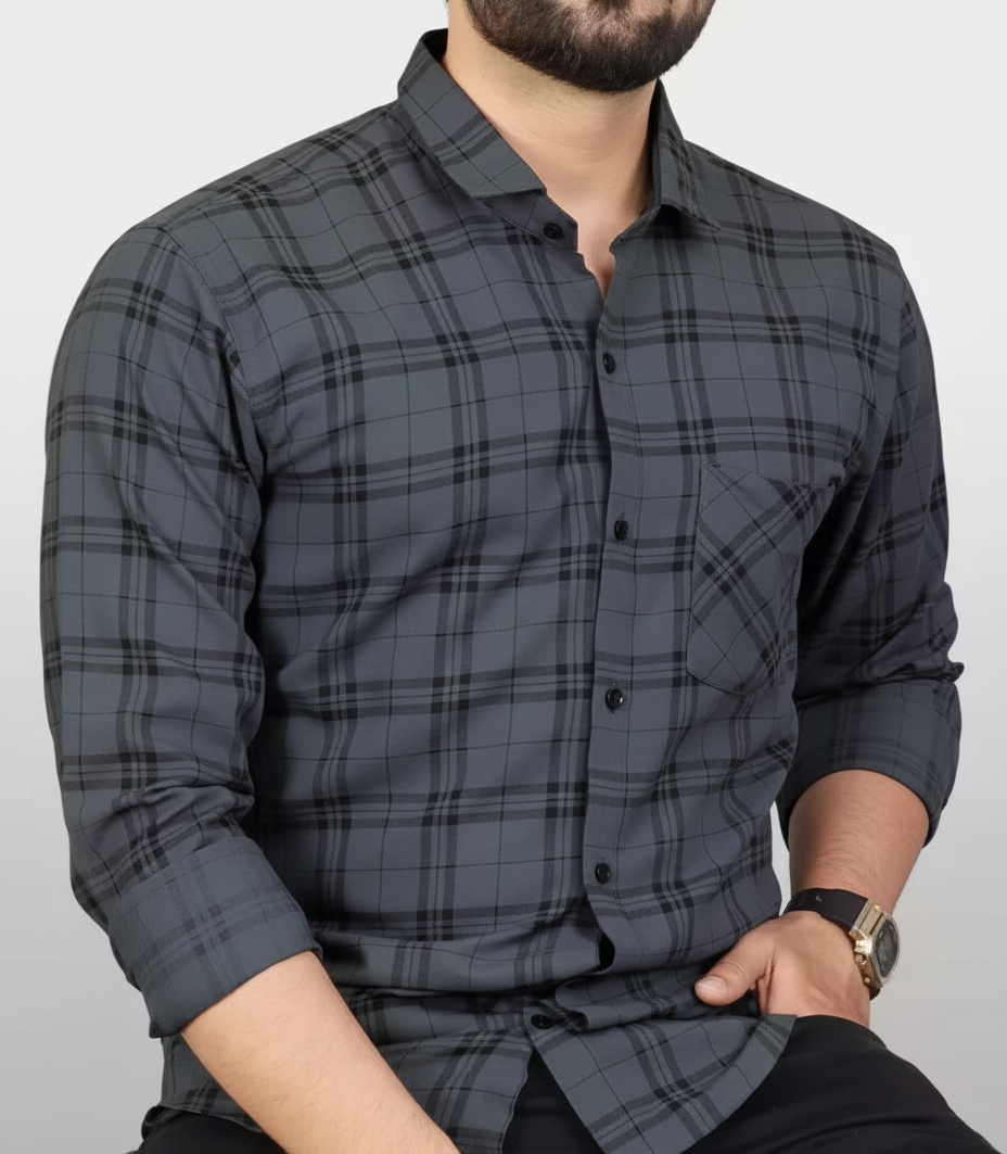Man wearing a gray plaid shirt against a white background