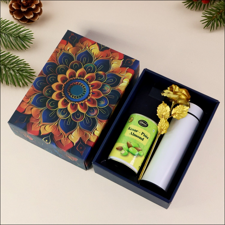 Festive gift hamper box with colorful design, containing almonds and decorative golden rose