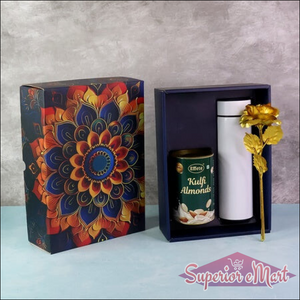 Festive gift hamper box featuring decorative design, kulfi almonds, and a gold flower in a sleek container