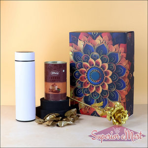 Festive gift hamper box with coffee blend, stylish canister, and decorative gold flower