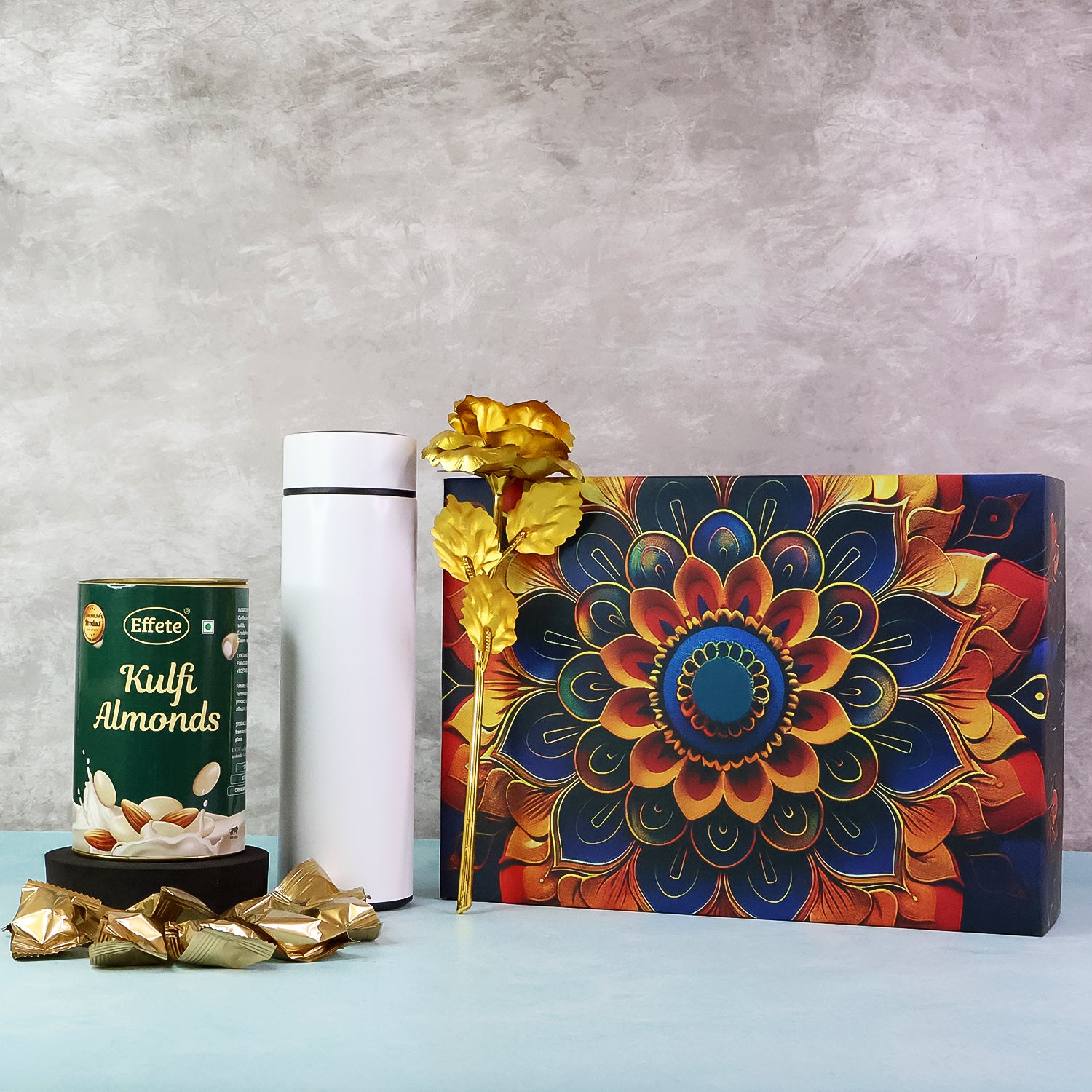 Festive gift hamper box with colorful design, kulfi almonds, and decorative items for special occasions