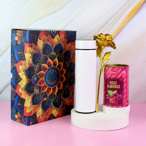 Festive gift hamper with stainless steel bottle, decorative flower, and rose almonds in an elegant box