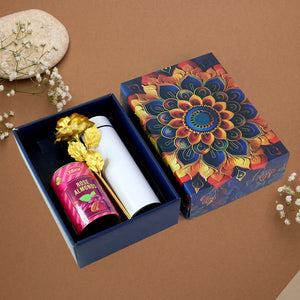 Festive gift hamper with stainless steel bottle featuring gourmet rose almonds and decorative packaging