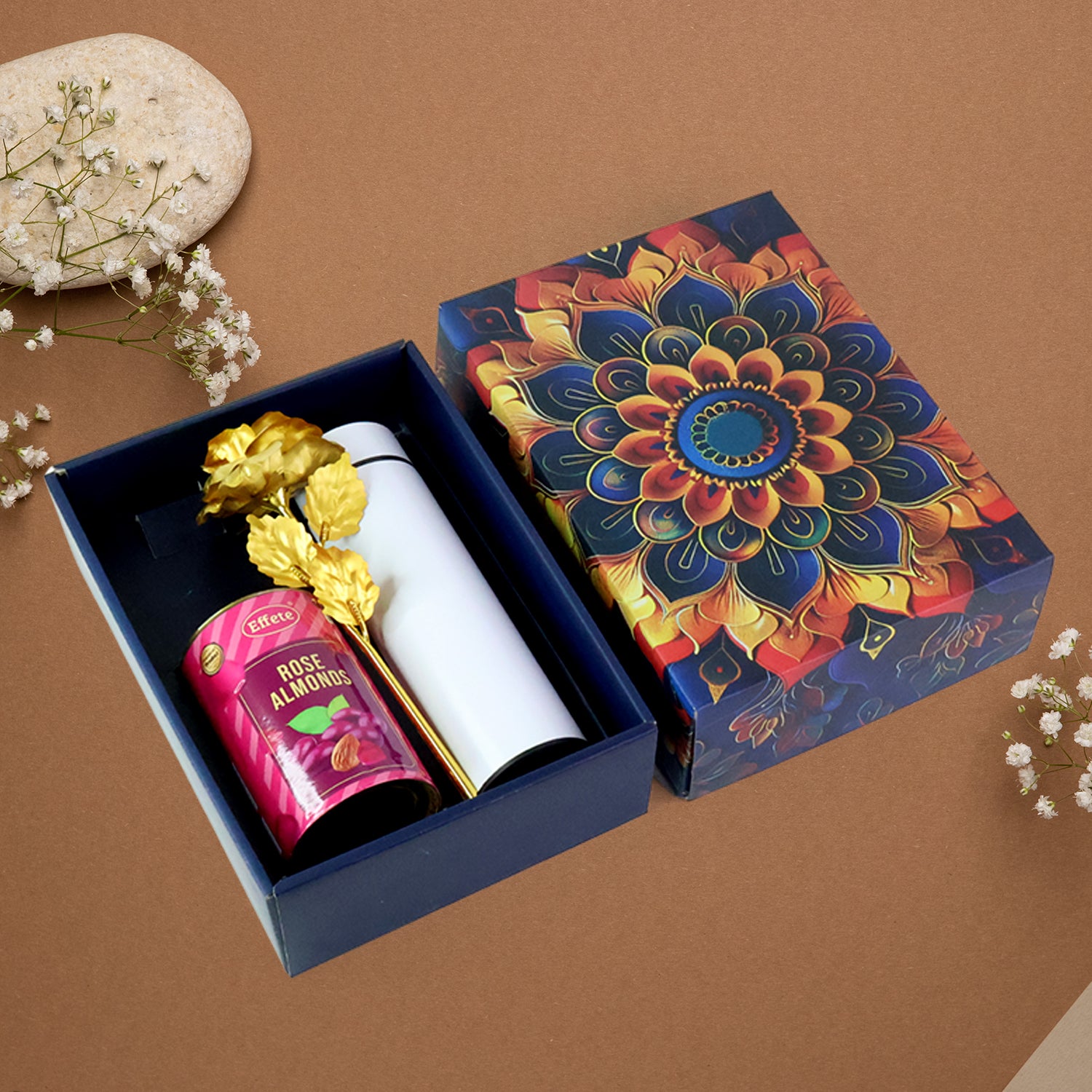 Festive gift hamper with stainless steel bottle featuring gourmet rose almonds and decorative packaging