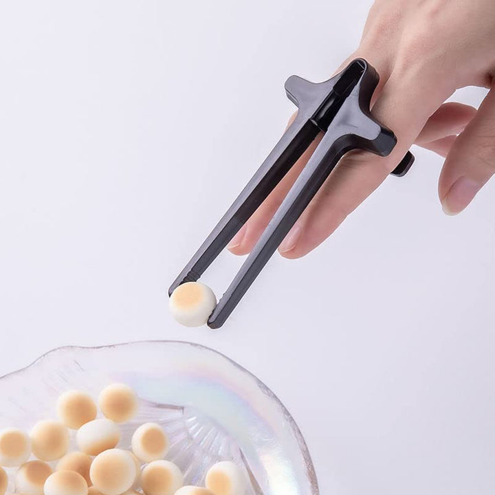 Convenient finger chopsticks for gamers designed for easy snacking while playing