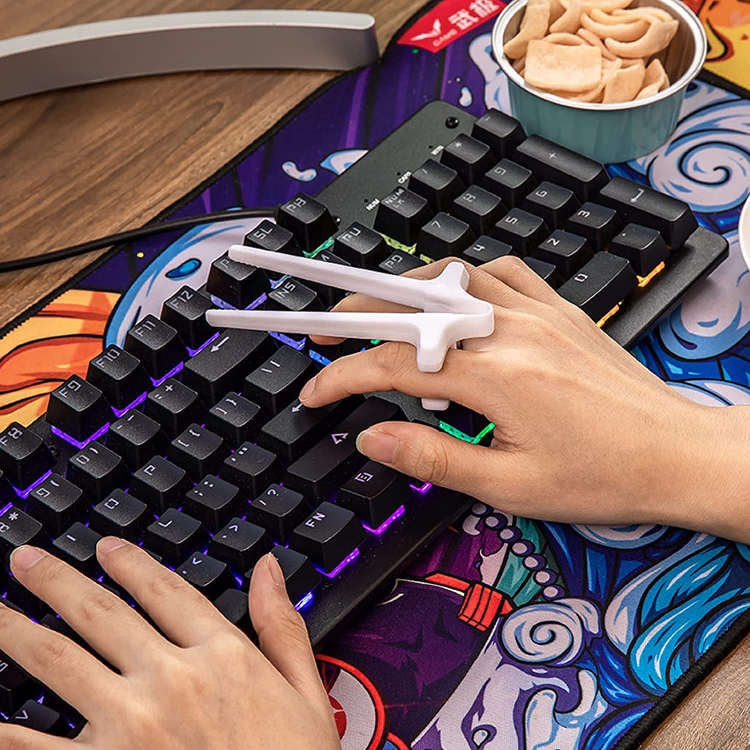 Finger chopsticks for gamers designed for easy snacking while playing video games