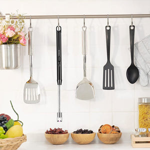 Flexible USB rechargeable lighter hanging in kitchen with cooking utensils and decorative flowers