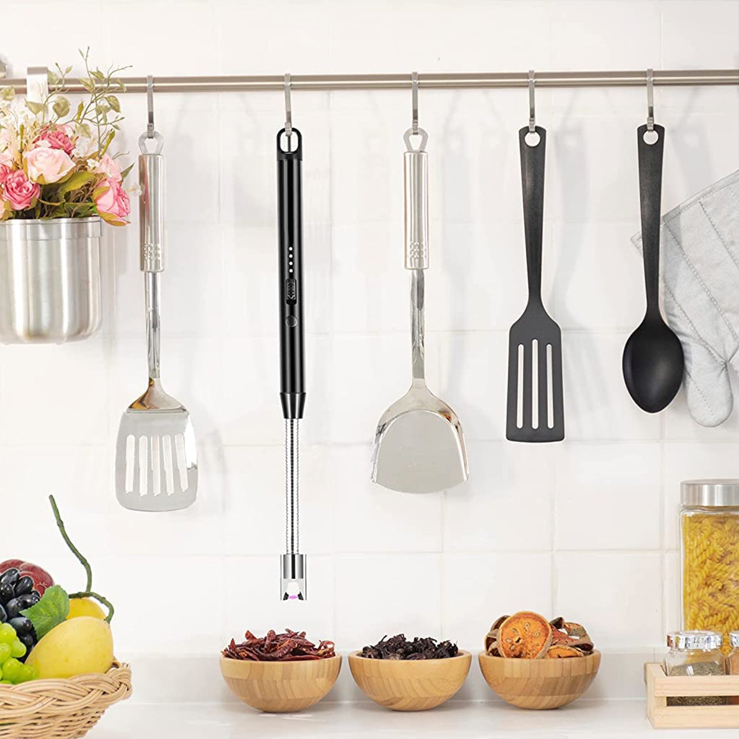 Flexible USB rechargeable lighter hanging in kitchen with cooking utensils and decorative flowers
