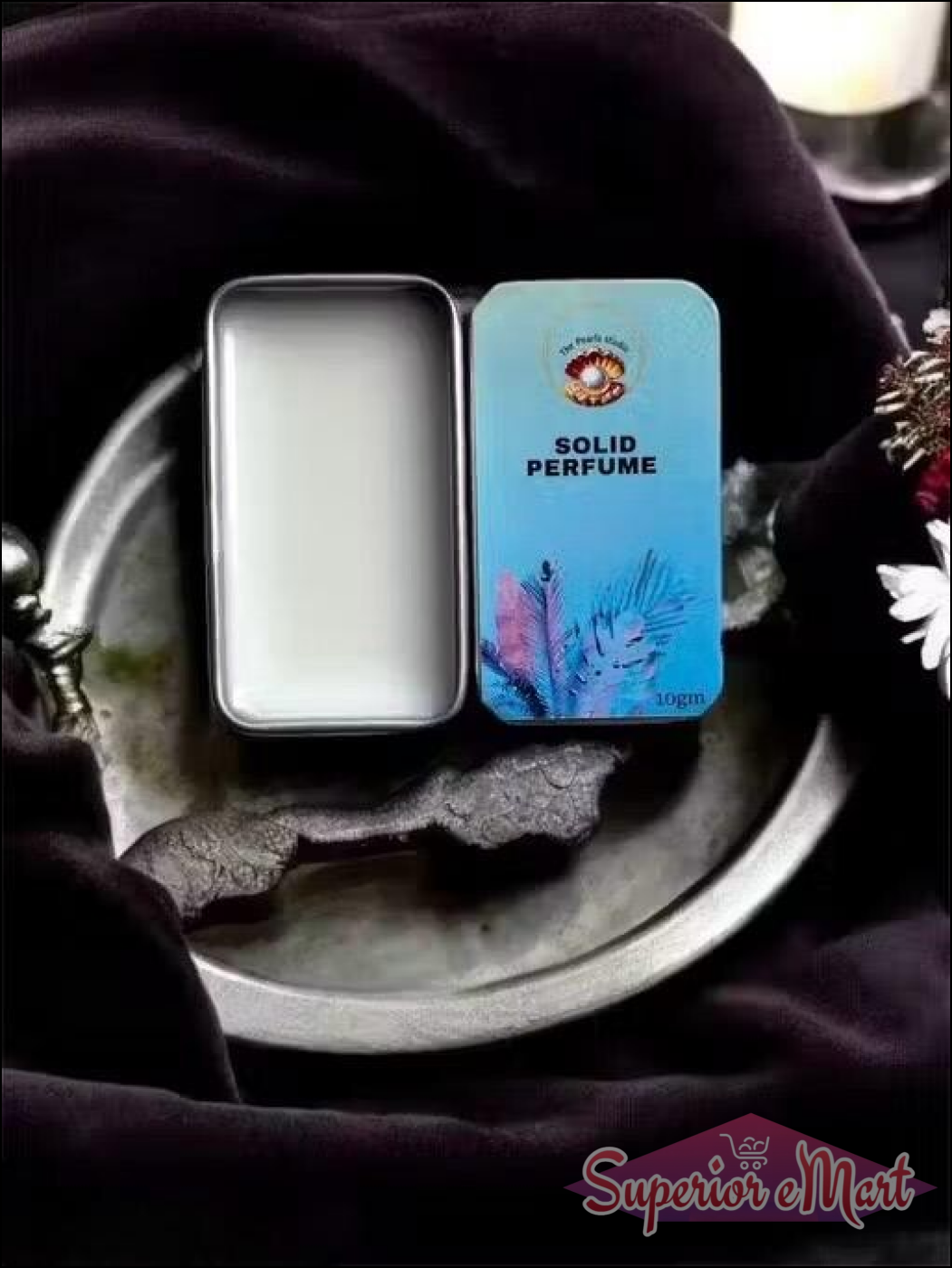 Floral solid perfume for unisex in a sleek metal tin on a decorative tray