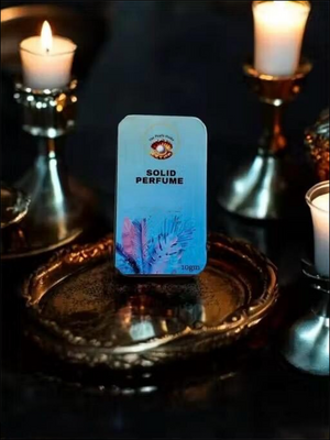 Floral solid perfume for unisex in decorative packaging on metallic tray with candles