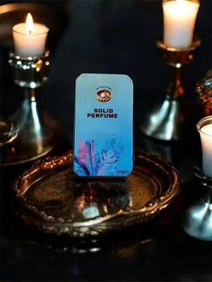 Floral solid perfume for unisex in decorative packaging on metallic tray with candles