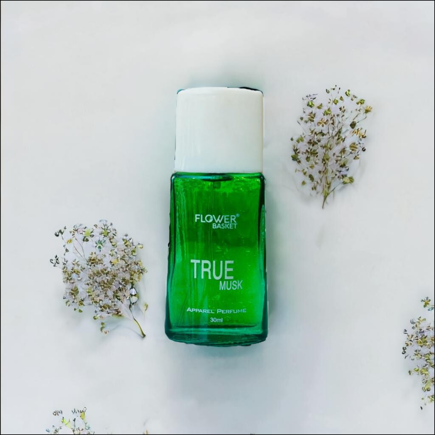 True Musk perfume 30ml by Flower Basket displayed with delicate white flowers for a refreshing look