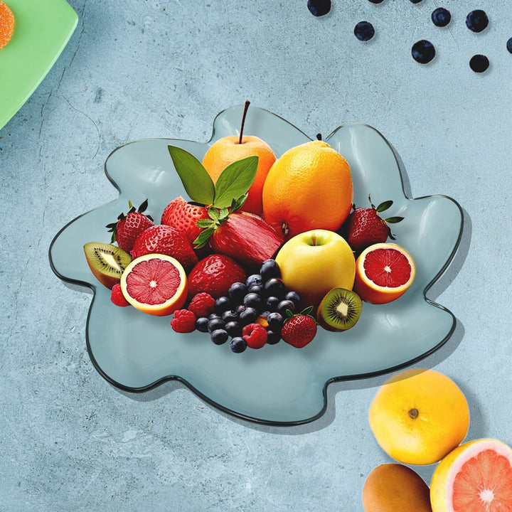 Flower shaped plastic fruit plate filled with colorful fruits including strawberries, oranges, and kiwis