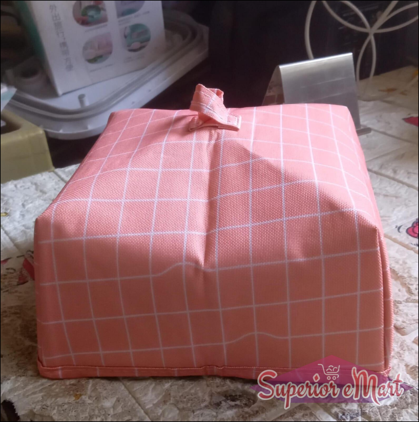 Foldable food cover in pink grid design for protecting meals and snacks from insects
