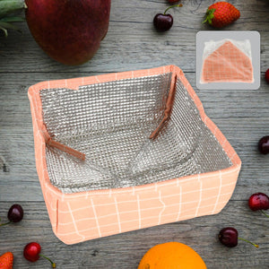 Foldable food cover in peach checkered design, ideal for protecting meals and snacks outdoors
