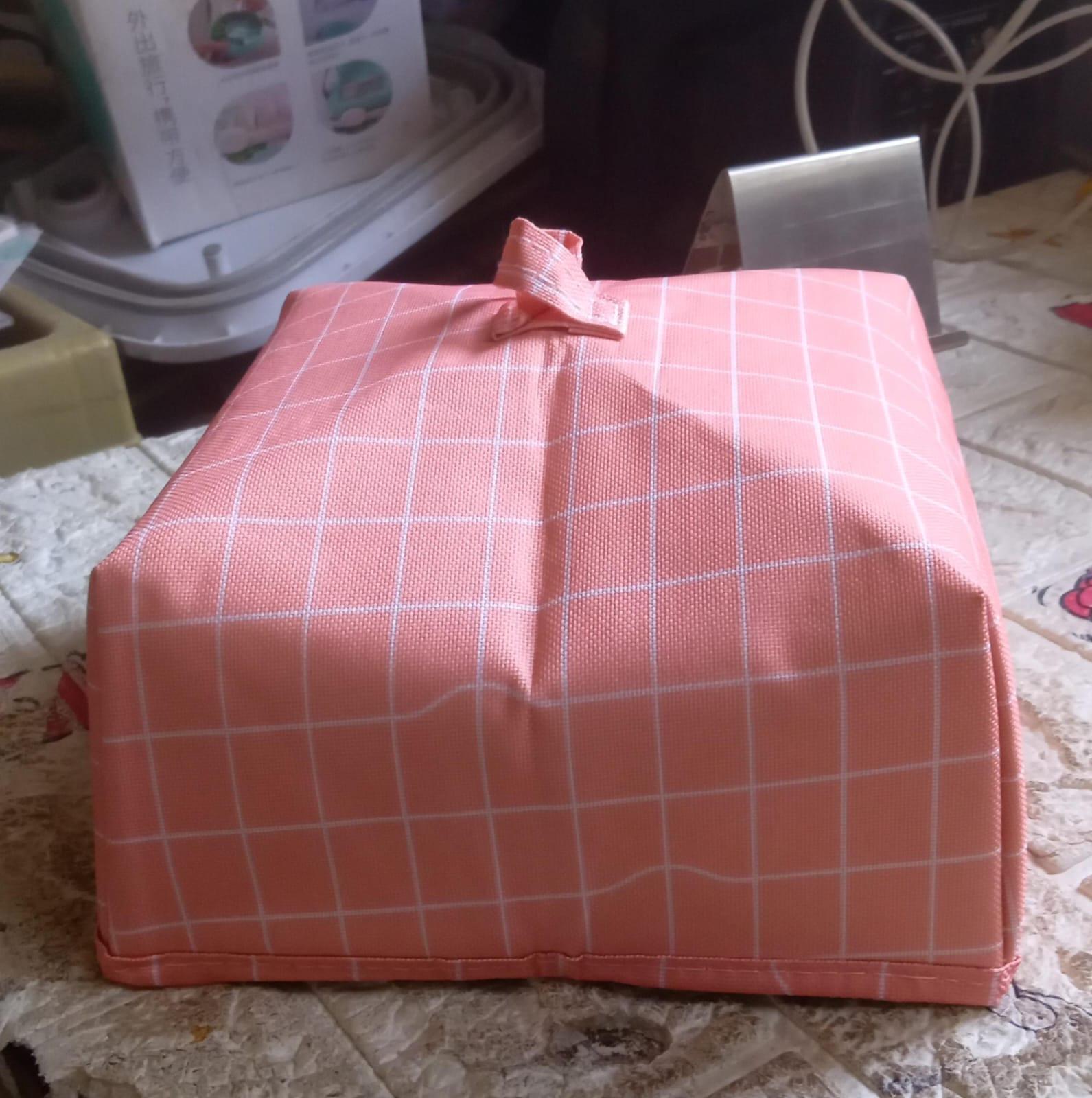Foldable food cover in pink grid design for protecting meals and snacks from insects