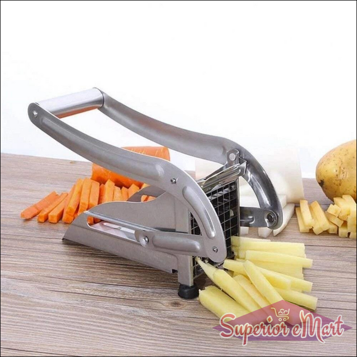 Stainless steel french fry cutter machine with sliced potatoes and carrots on a wooden surface