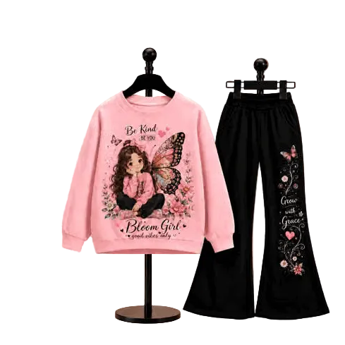 A two-piece girls' outfit set displayed on black hangers against a plain white background. The set includes a light pink long-sleeve sweatshirt with a colorful cartoon butterfly girl graphic and text, paired with black wide-leg pants featuring butterfly and floral prints.