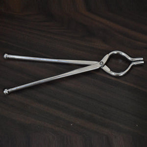 Stainless steel utensil holder tongs for easy food handling and serving in the kitchen