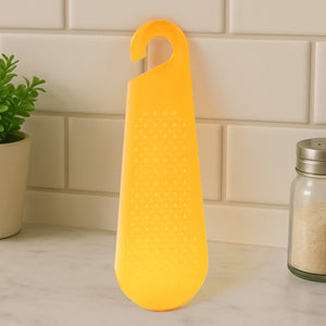 Yellow garlic and ginger grater tool with a convenient handle for easy grating in the kitchen