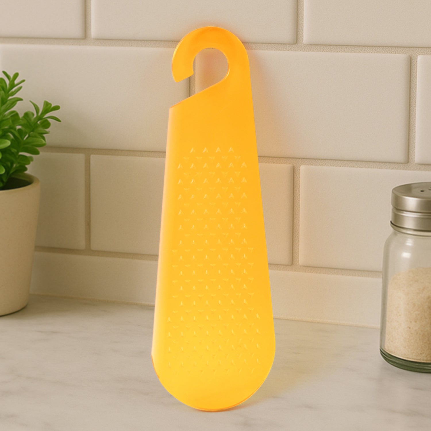 Yellow garlic and ginger grater tool with a convenient handle for easy grating in the kitchen