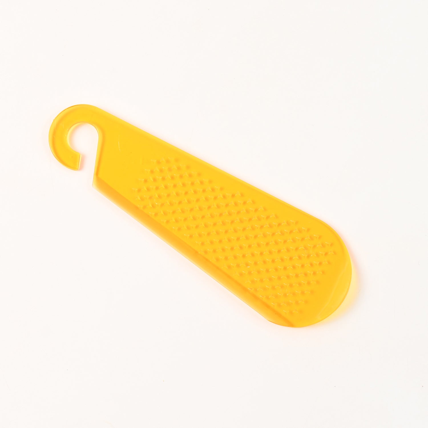 Yellow garlic and ginger grater tool with a textured surface for efficient grating