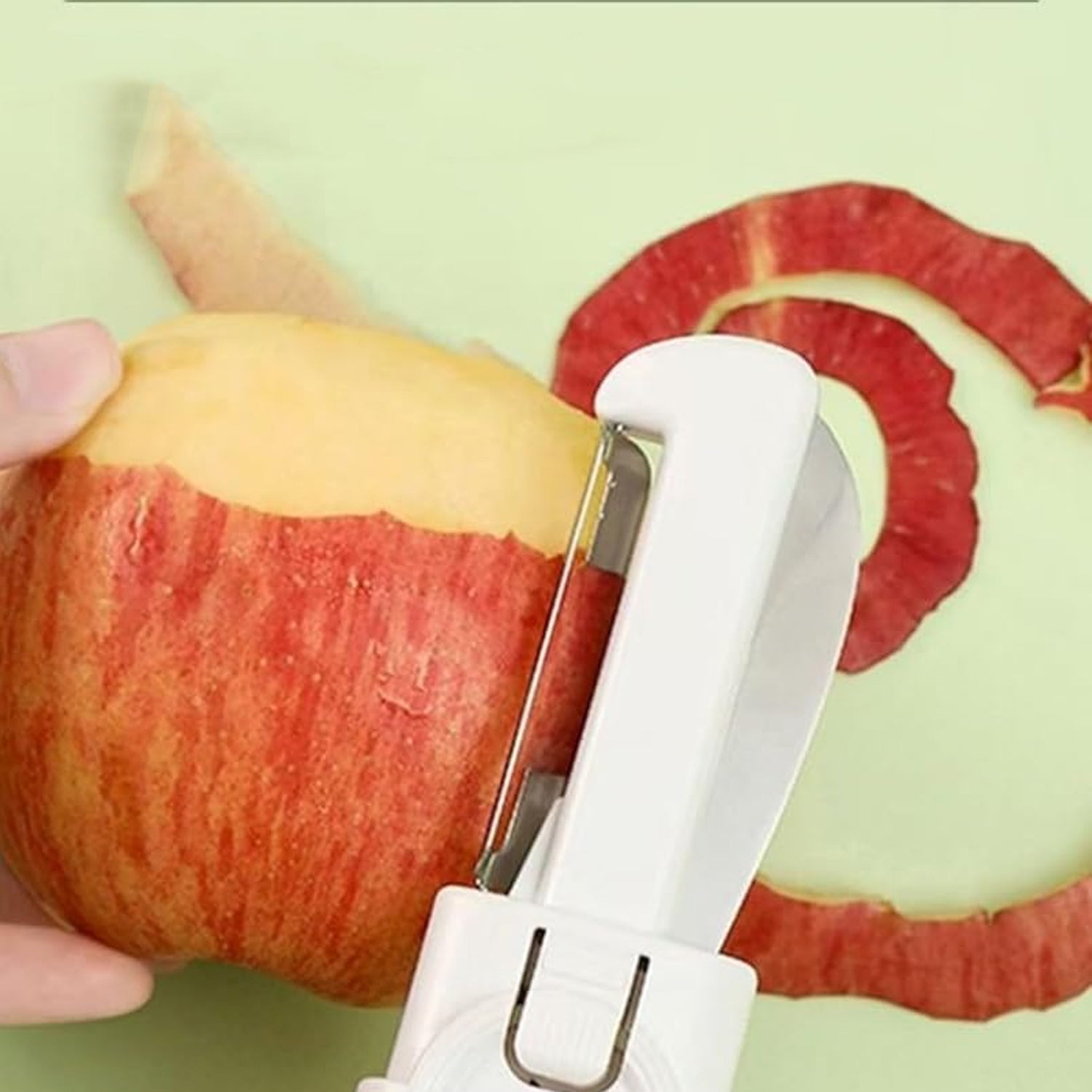 Superior eMart 2-in-1 knife and peeler peeling the skin off a red apple with a white handle