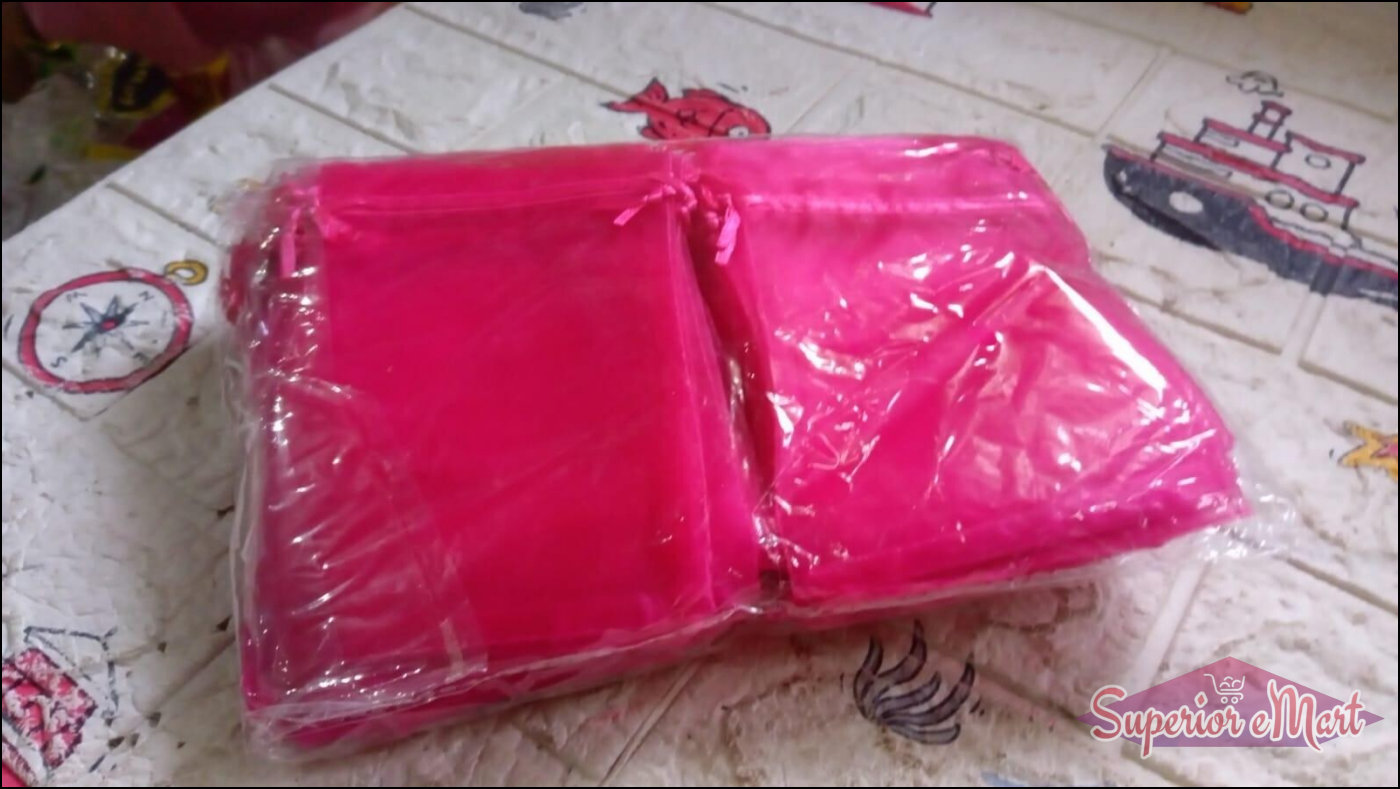 Pack of small organza gift bags in vibrant pink color, ideal for party favors and special occasions