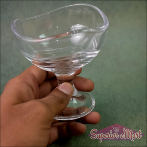 Hand holding a clear glass footed dessert bowl set for serving elegant desserts