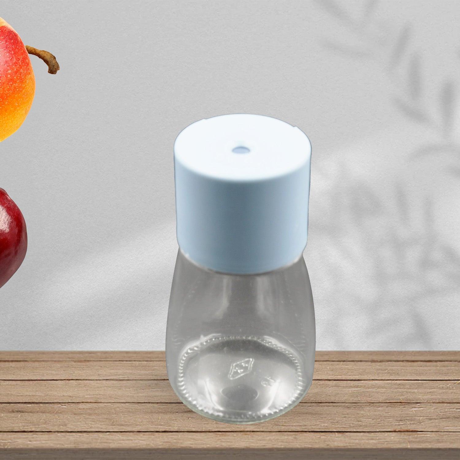 Stylish glass salt dispenser for cooking with a light blue lid, perfect for seasoning dishes
