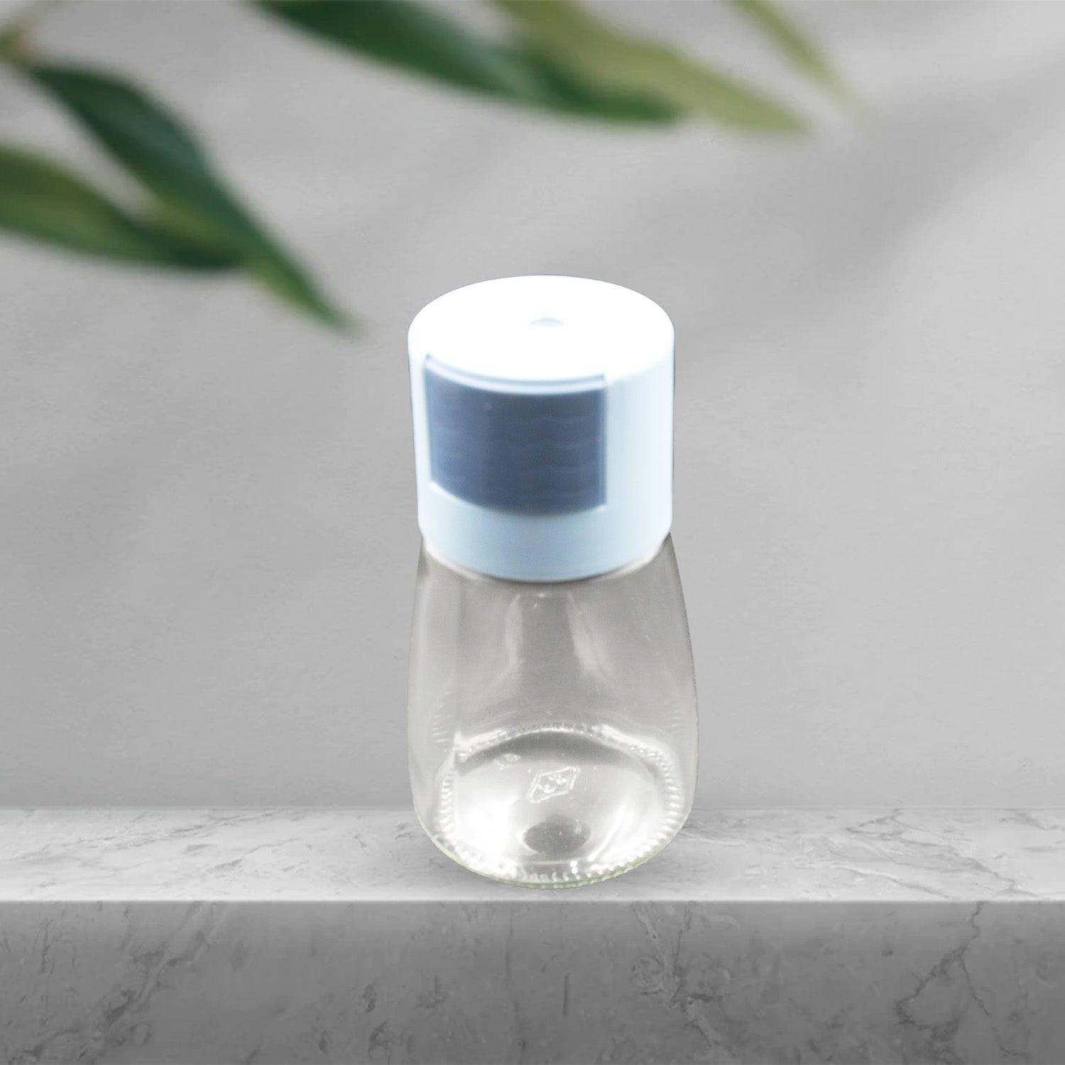 Glass salt dispenser for cooking with a blue lid, perfect for adding seasoning to dishes