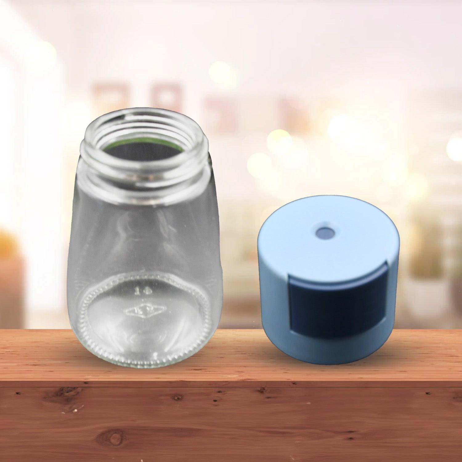 Clear glass salt dispenser for cooking with a blue cap for easy pouring and fine control