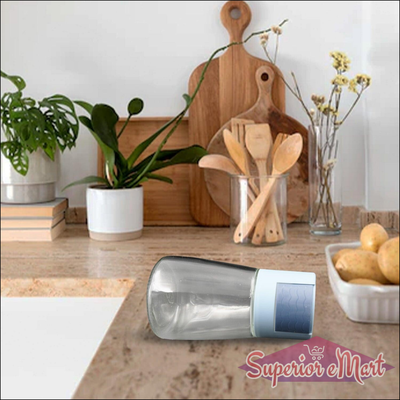 Stylish glass salt dispenser for cooking on a kitchen countertop with plants and utensils