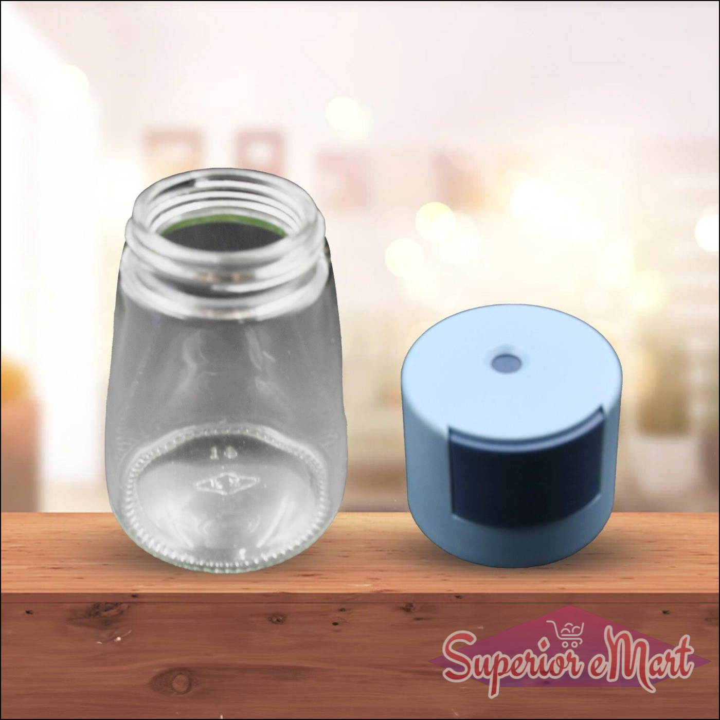 Clear glass salt dispenser for cooking with a blue cap for easy pouring and fine control