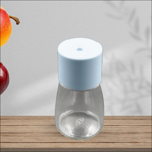 Stylish glass salt dispenser for cooking with a light blue lid, perfect for seasoning dishes