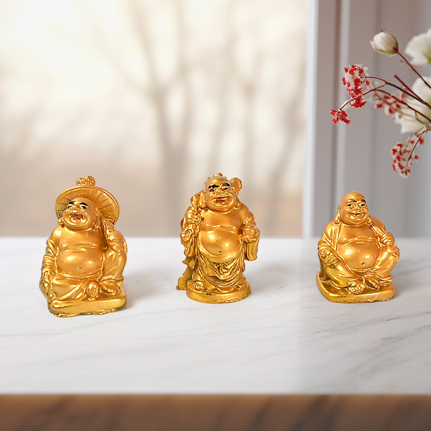 Three Golden Laughing Buddha statues for home decor, each featuring unique poses and smiles