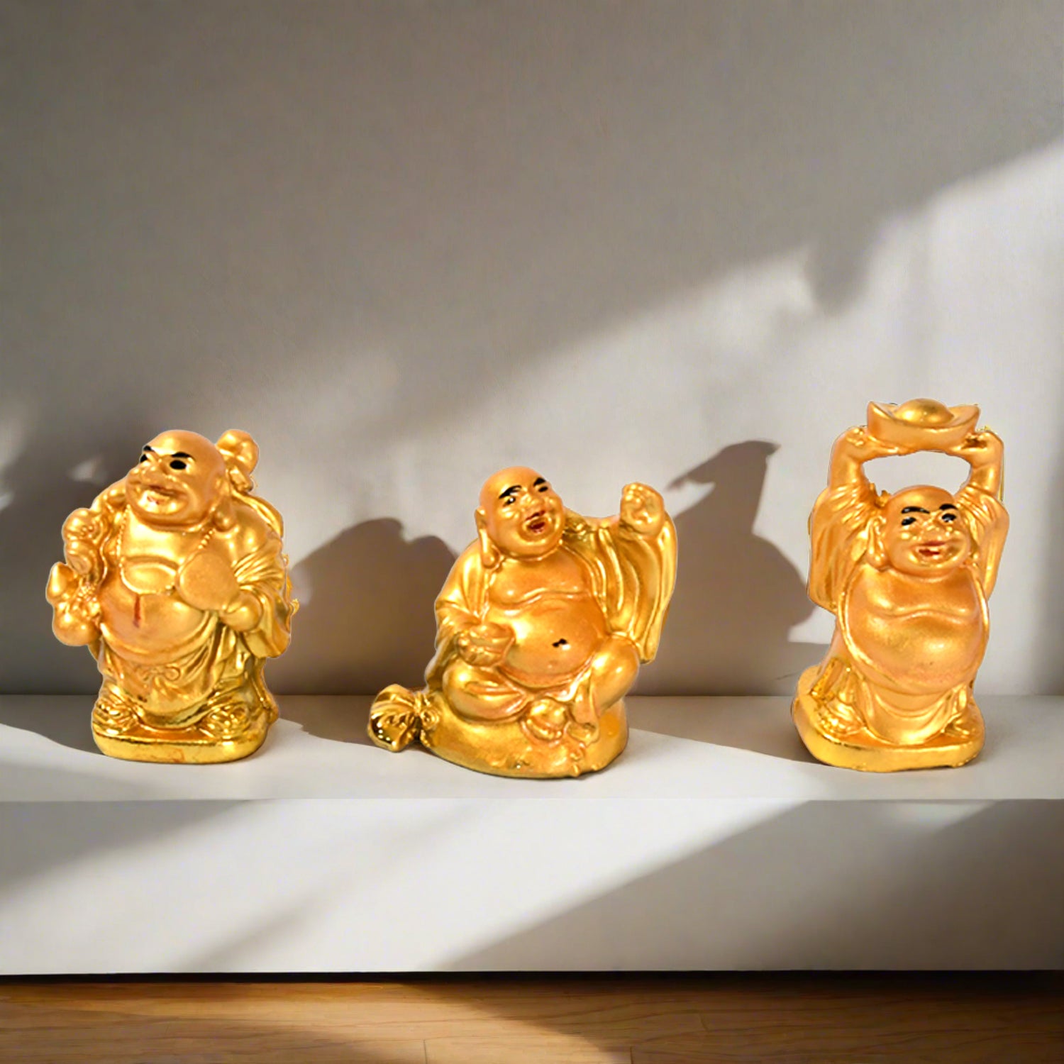 Set of three Golden Laughing Buddha statues in various poses for home decor