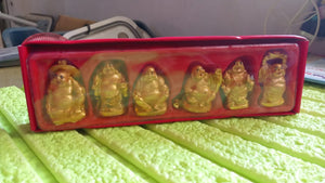 Set of six Golden Laughing Buddha statues in a red box for home decor and prosperity