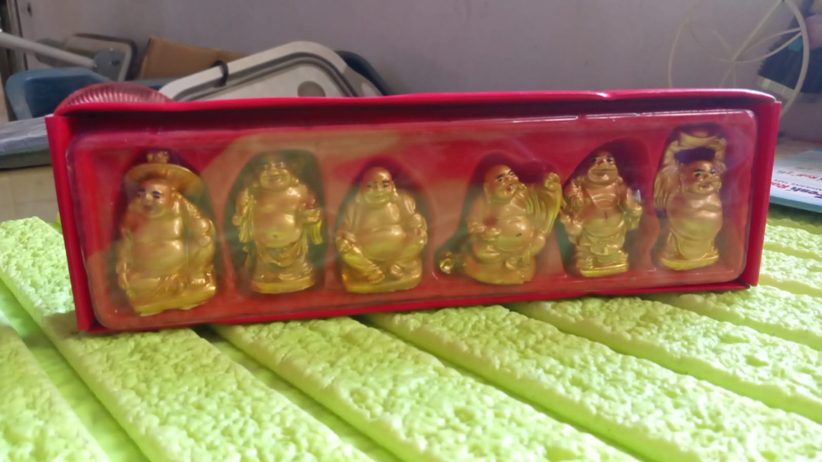Set of six Golden Laughing Buddha statues in a red box for home decor and prosperity