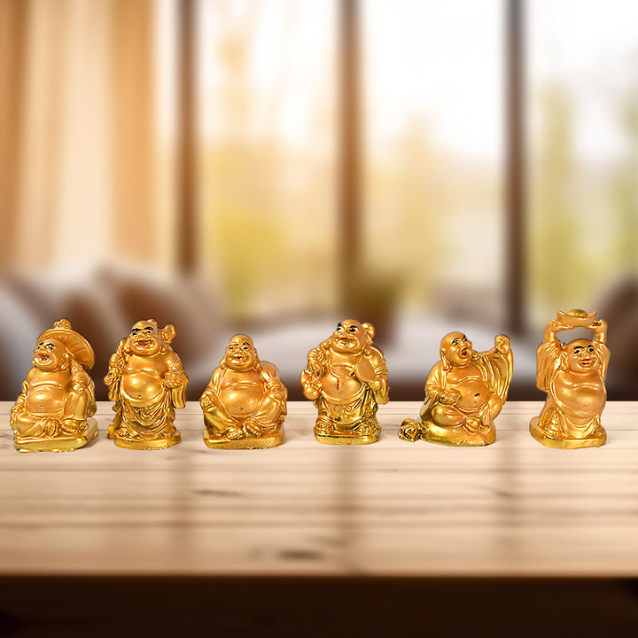Set of Golden Laughing Buddha statues on a wooden table, perfect for home decor and positivity.