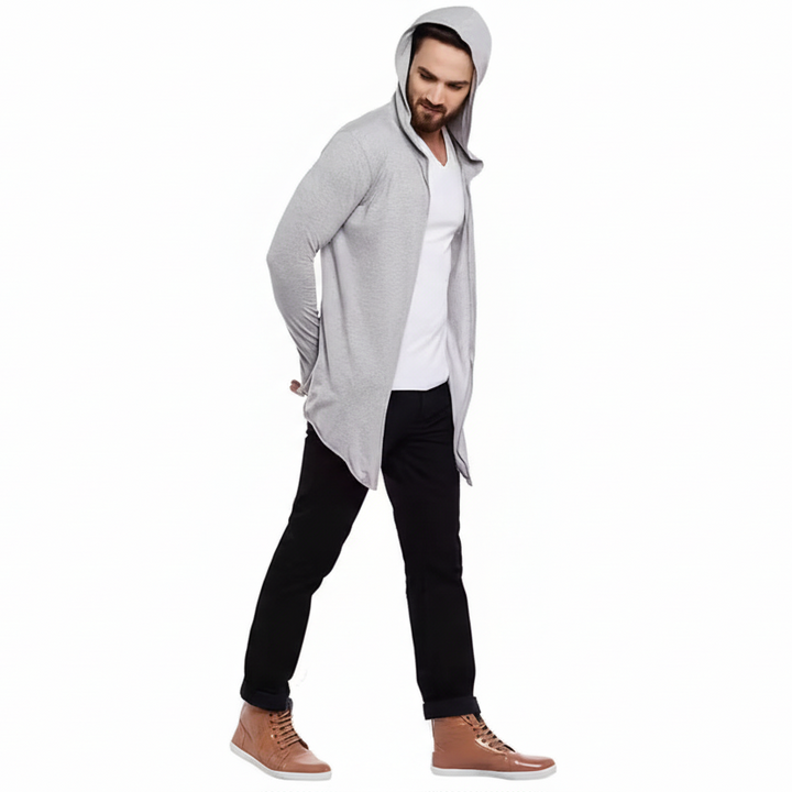 Man wearing a gray hooded jacket over a white shirt on a white background