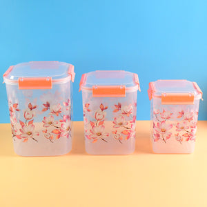 Set of three floral airtight storage containers with pink flower design and orange clasps for kitchen organization