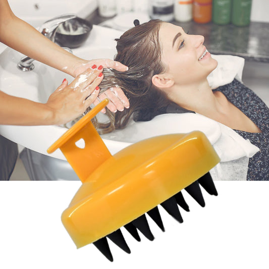 Handheld scalp massager in yellow for a relaxing hair washing experience at home or salon