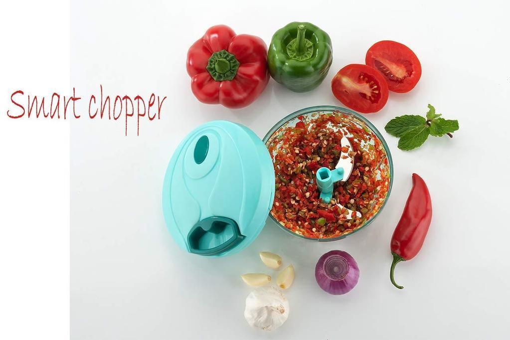 Handheld vegetable chopper with chopped vegetables and fresh herbs for easy meal preparation