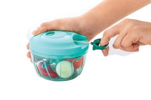 Handheld vegetable chopper in use with colorful vegetables, perfect for quick meal prep