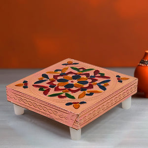 Handcrafted puja table in pink with colorful floral designs, perfect for home decor and spiritual practices