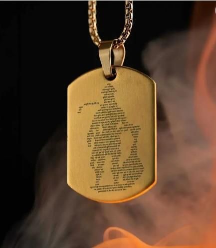 Hanuman Chalisha pendant in gold with engraved design on a matching chain for spiritual wear.