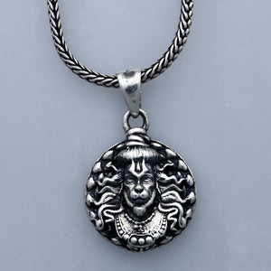 Hanuman facelocket necklace with intricate silver design and braided metal chain