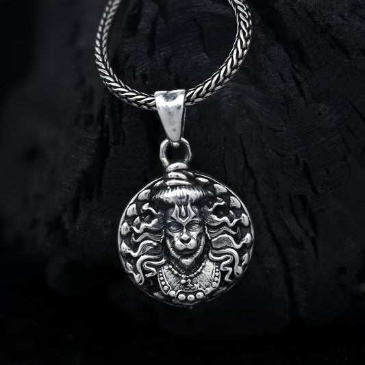 Hanuman facelocket necklace in silver featuring intricate detailing and a braided chain design